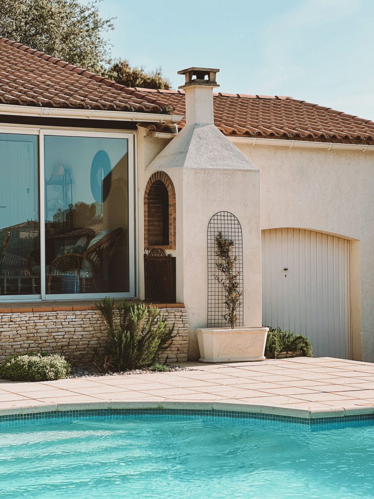 Luxurious home featuring a spacious patio and swimming pool.